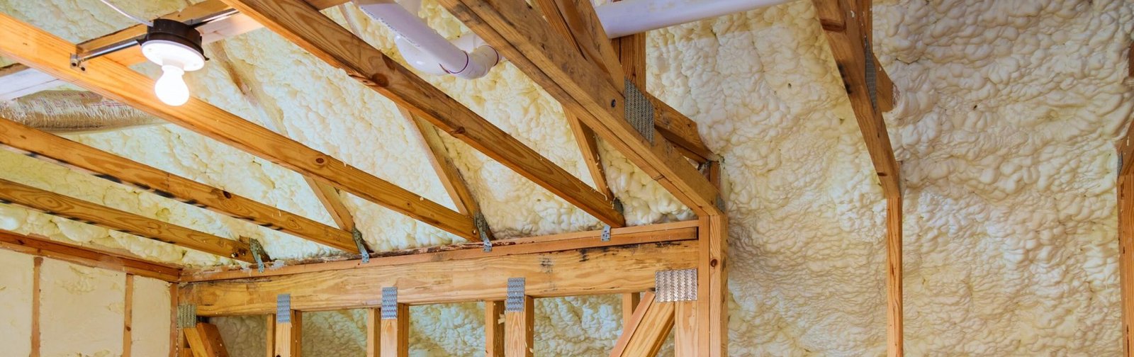 Foam plastic insulation installed in the sloping ceiling of a new frame house.